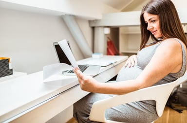 Pregnant woman reviewing charts and graphs
