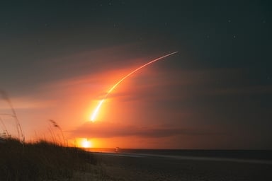 SpaceX Falcon 9 rocket trail on the beach.