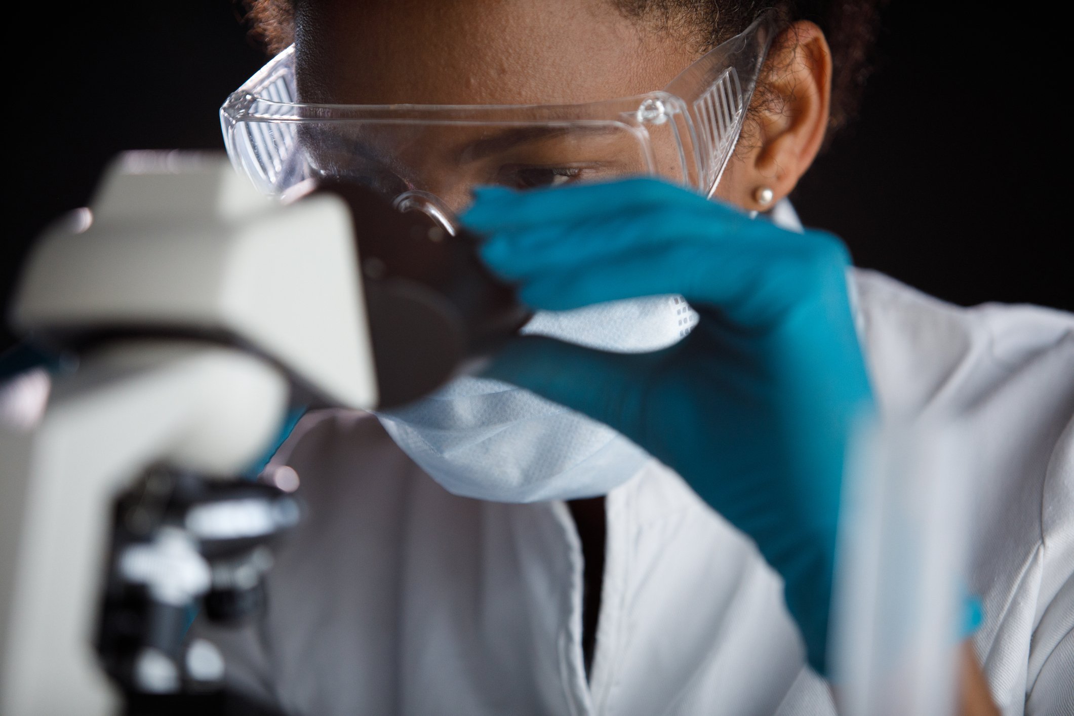 Scientist looking through microscope