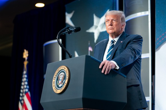 Donald Trump delivering remarks from behind the presidential podium.