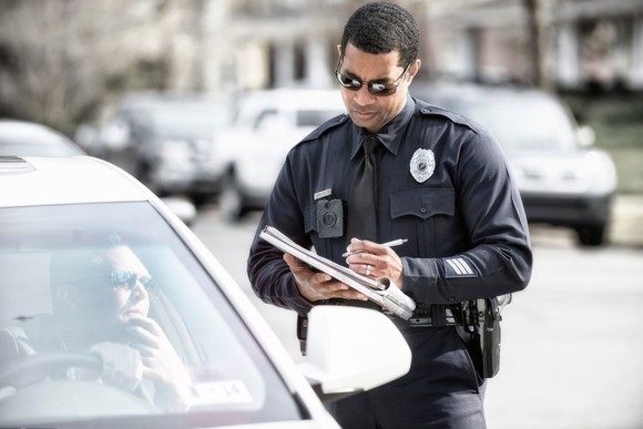 An officer wearing an Axon body camera.