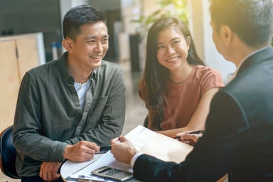 People sitting with papers getting a loan