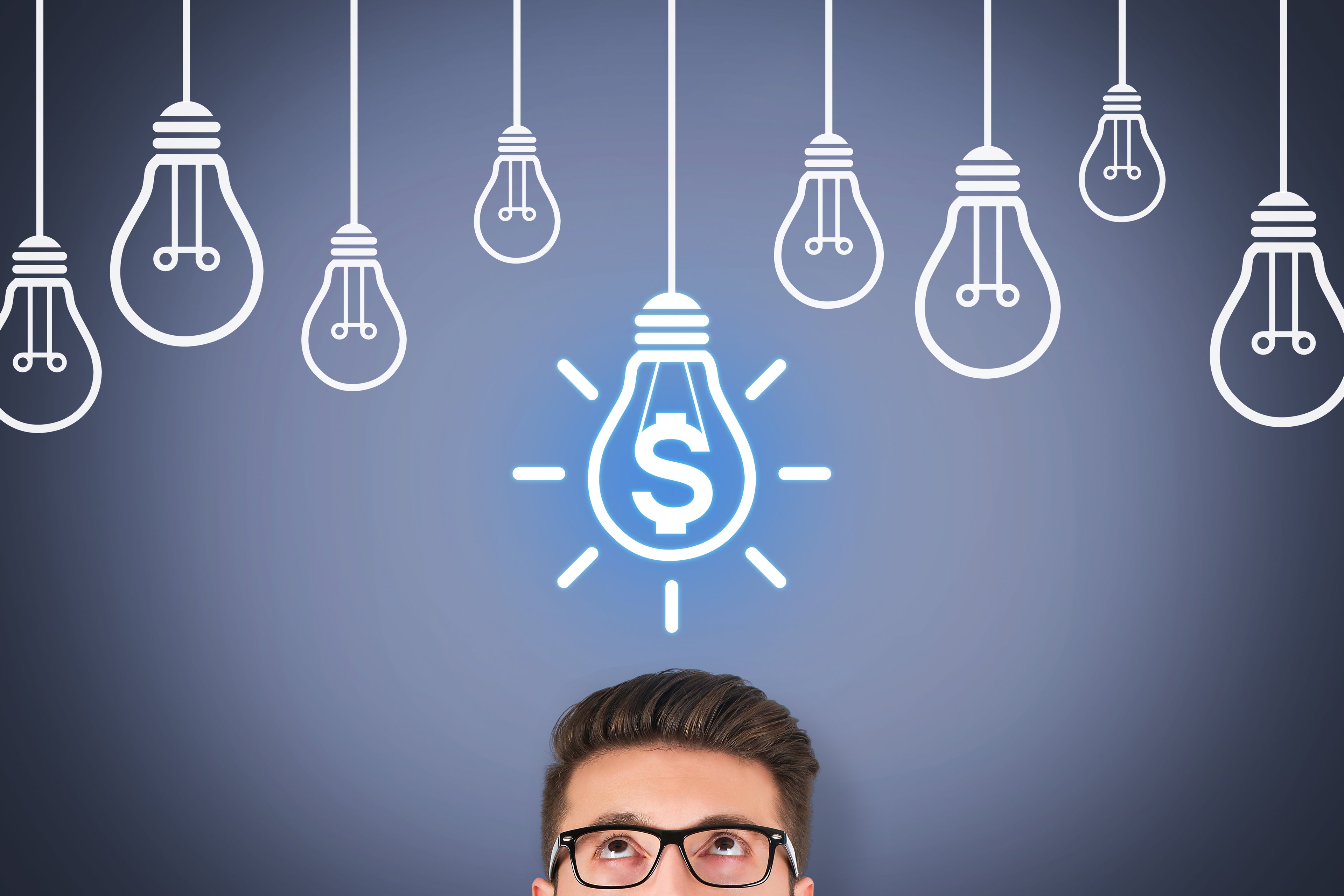 A person looking up at a lightbulb, inside of which is a glowing dollar sign.