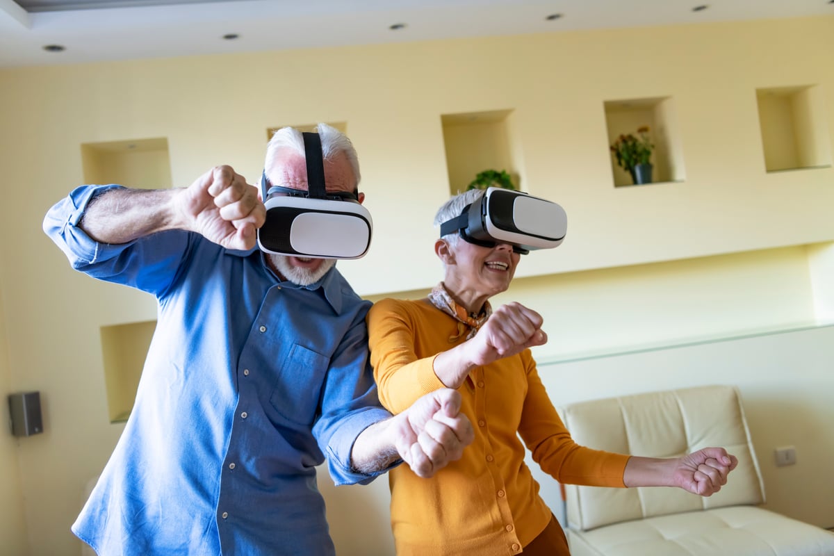 2 people looking at virtual reality goggles