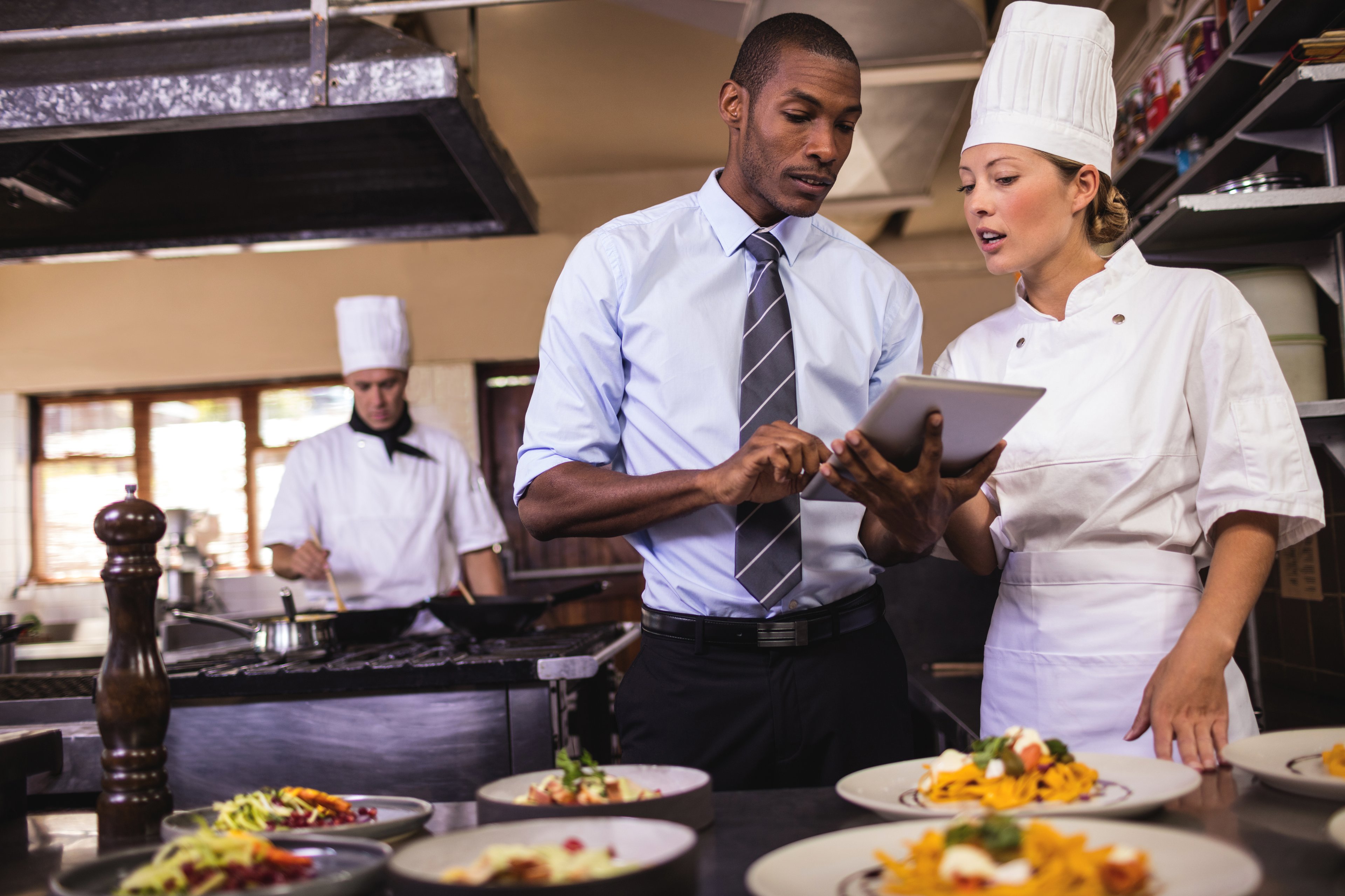 Restaurant staff working with tablet computer