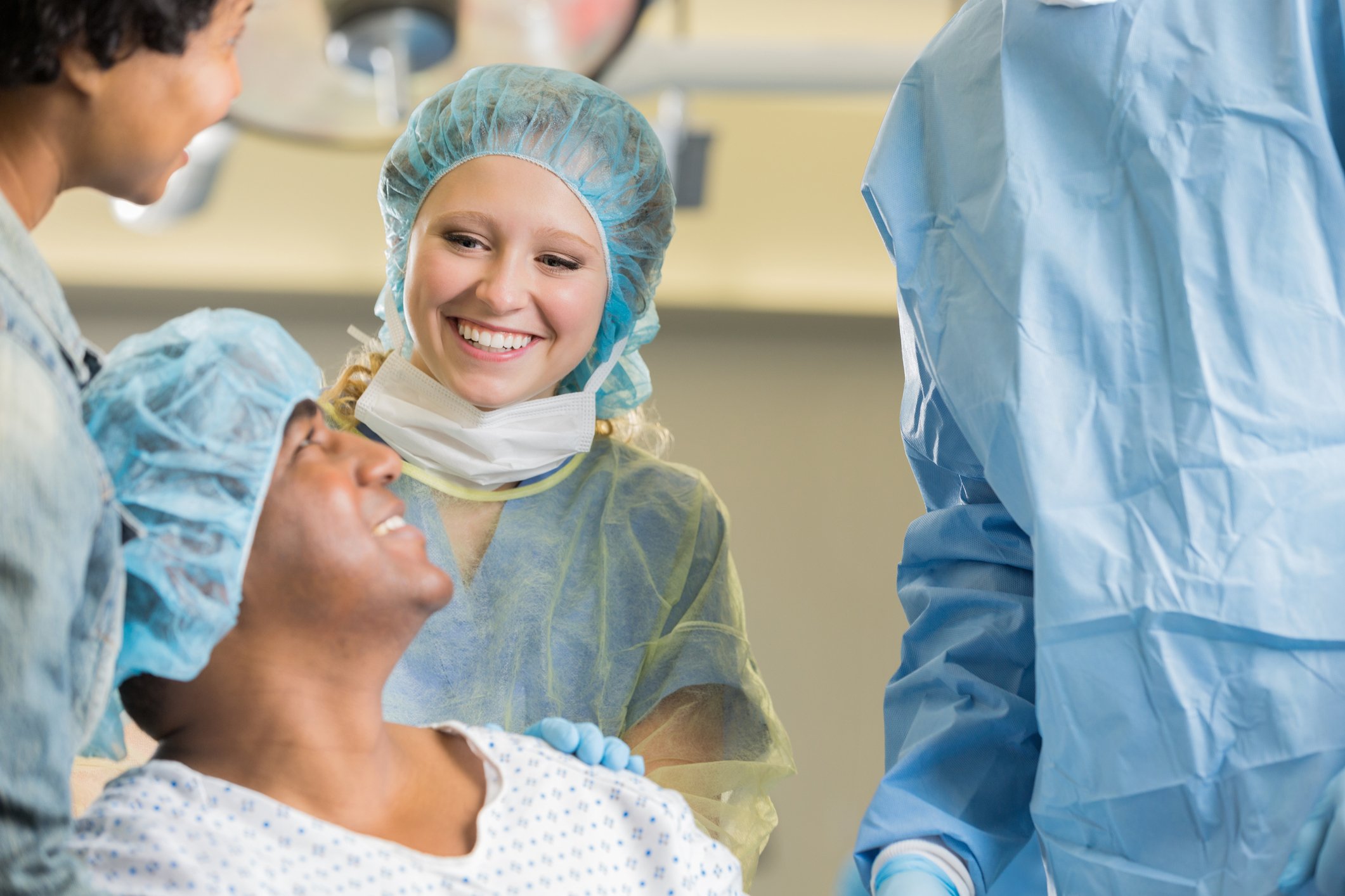 Healthcare workers speak to a patient before surgery.