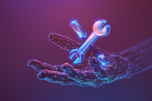 Rendering of a digital hand holding a wrench and a screwdriver. 