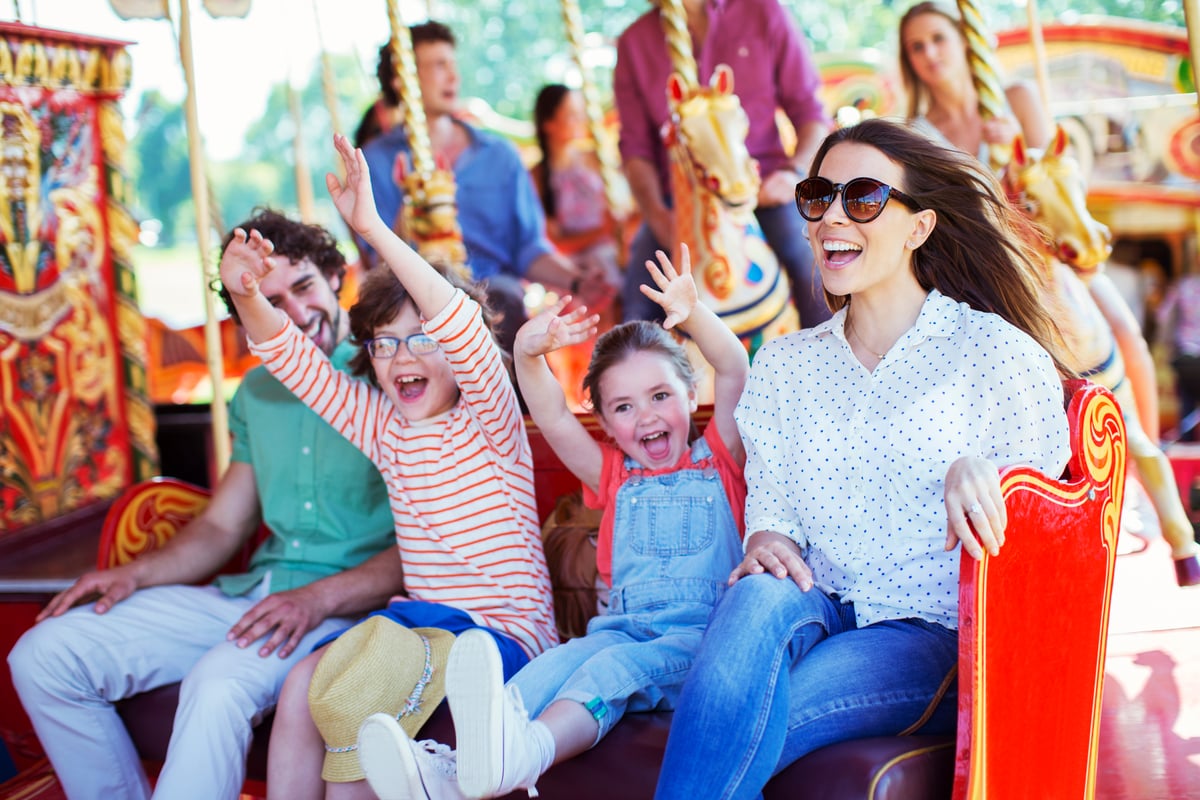 Group of people enjoying a ride on a colorful carousel.