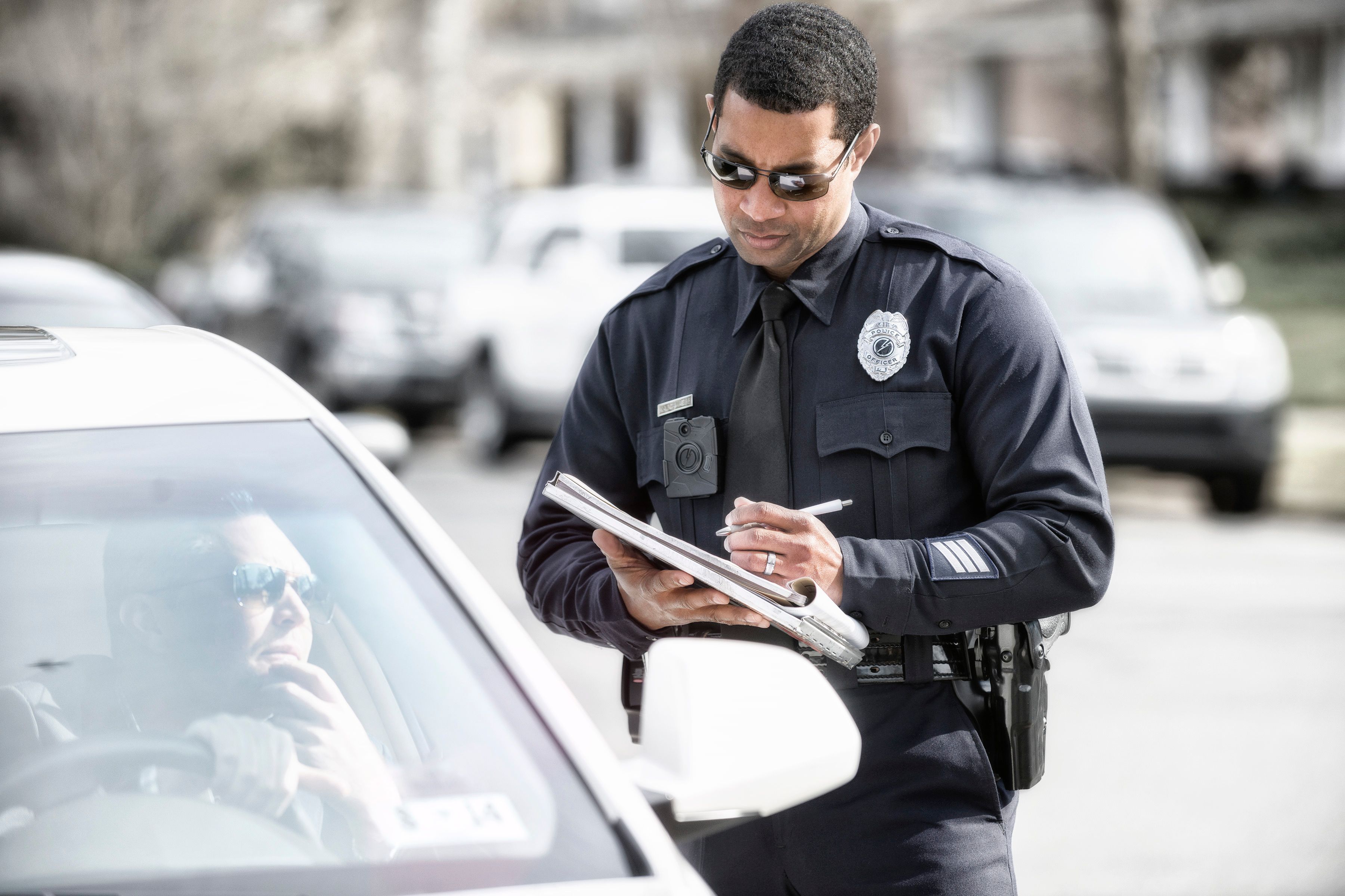 A police officer wearing an Axon body camera.