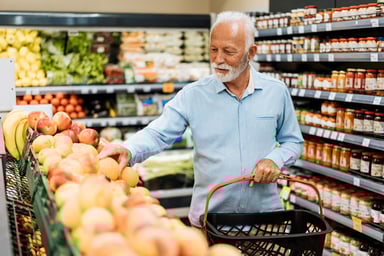 Person picking groceries in a store.