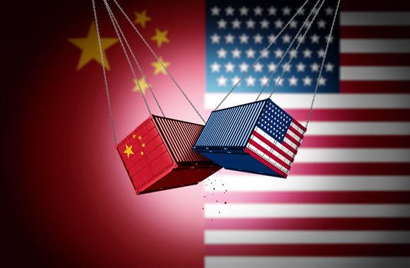 Shipping containers labeled with U.S. and Chinese flags collide.