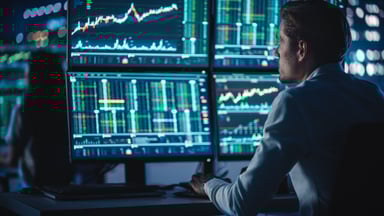 Trader watching multiple trading screens