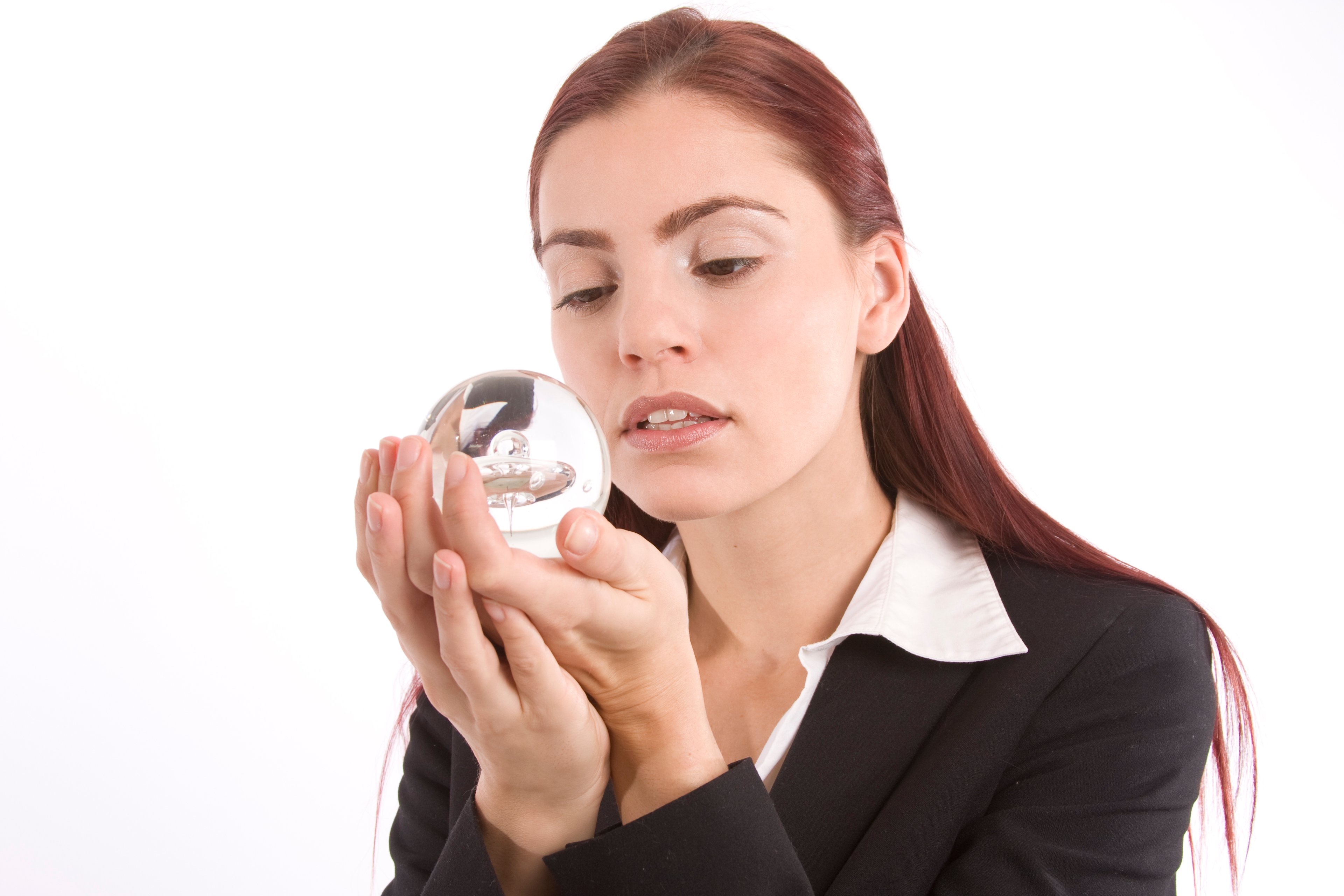 Someone is holding a crystal ball and is gazing into it.