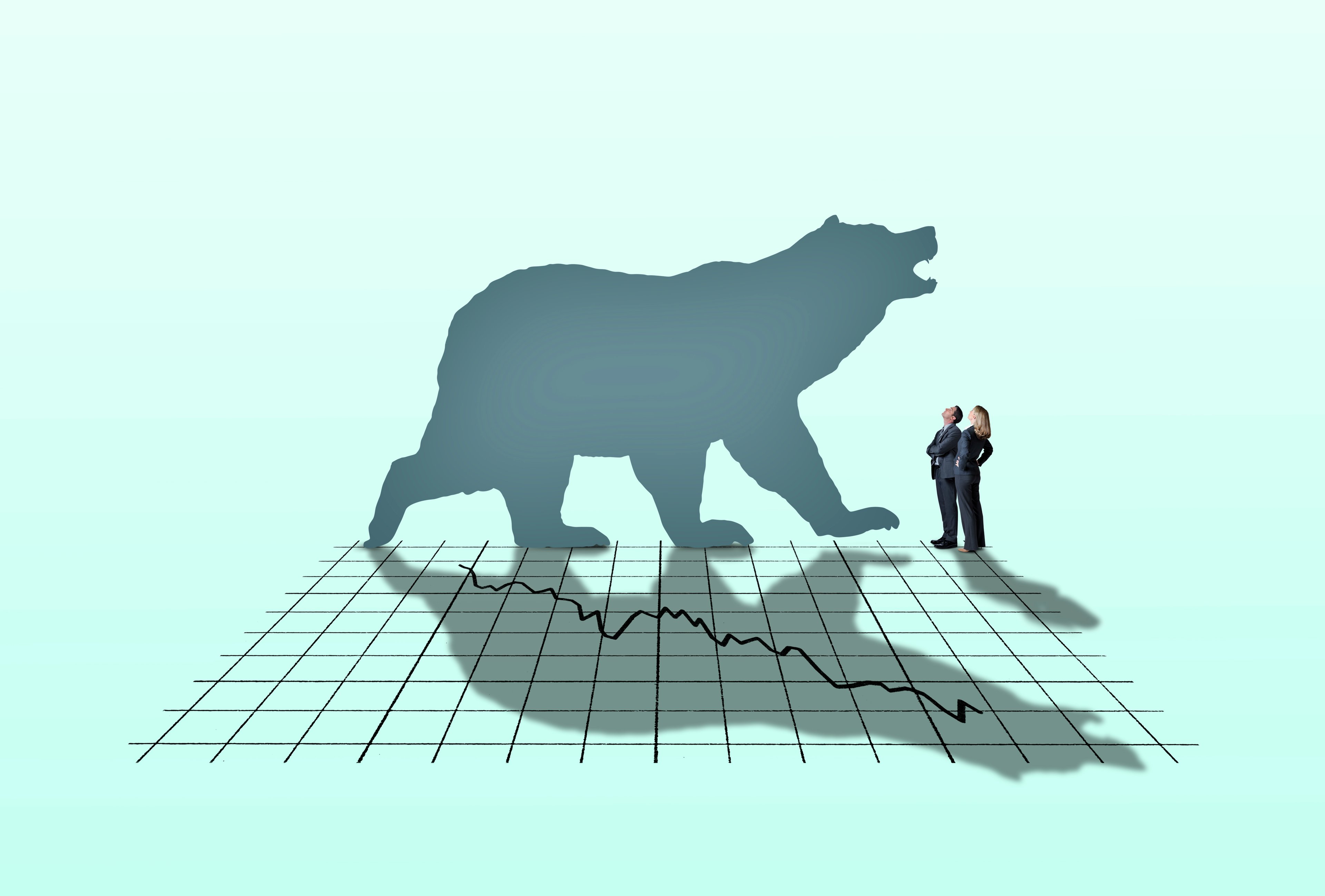 Shadow of a bear on a downward-sloping stock market graph. 
