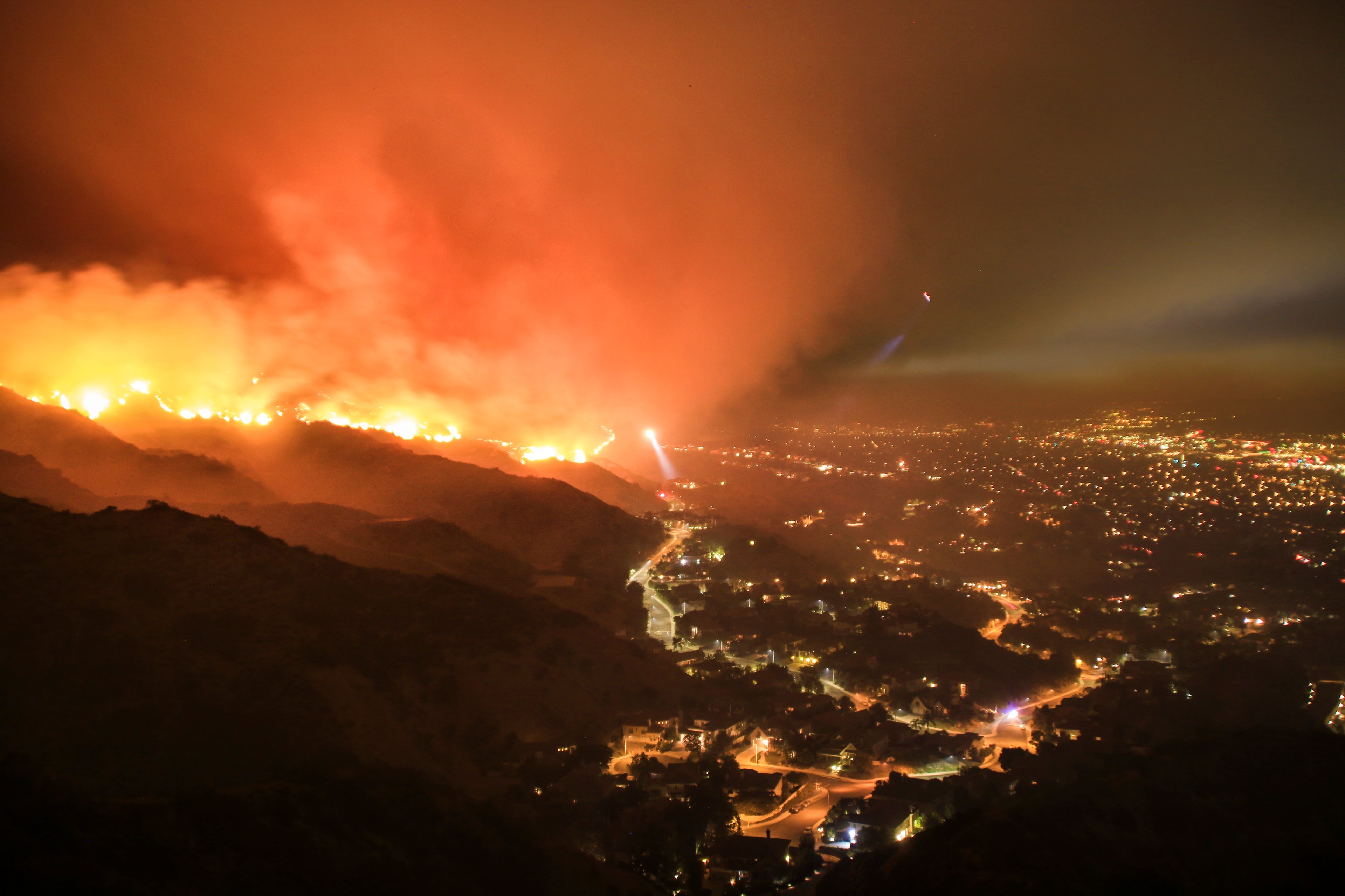 forest fire near city burning