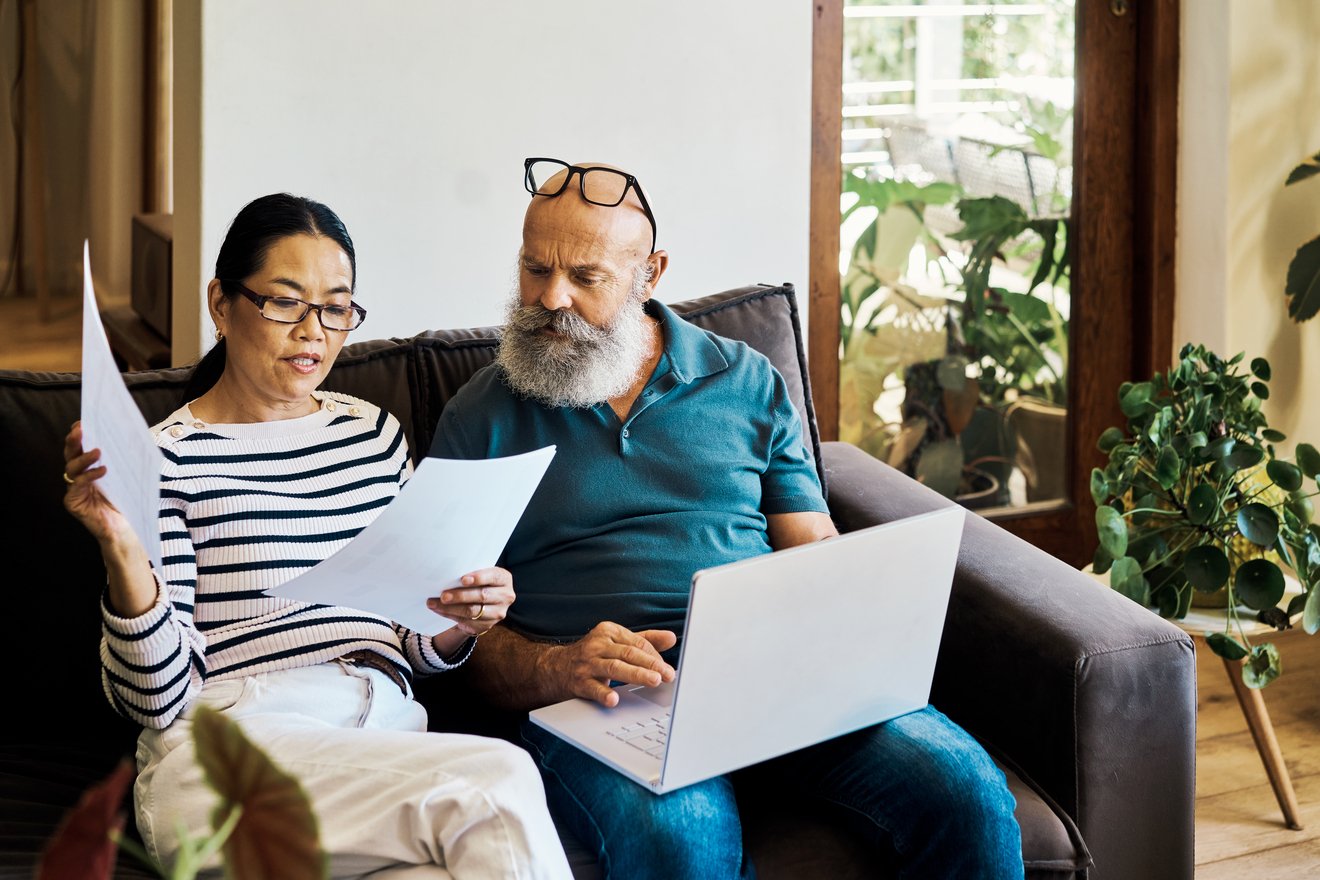 Two people looking at documents together.