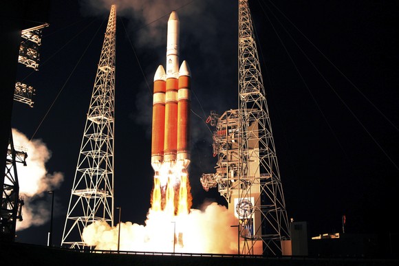 ULA Delta IV rocket launch at night.