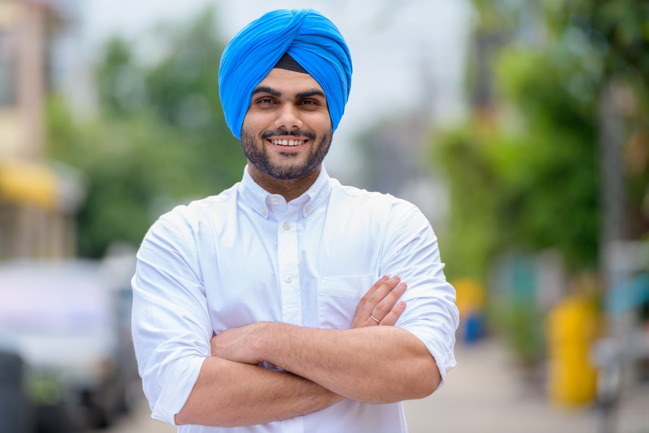 Getty - smiling arms crissed white shirt