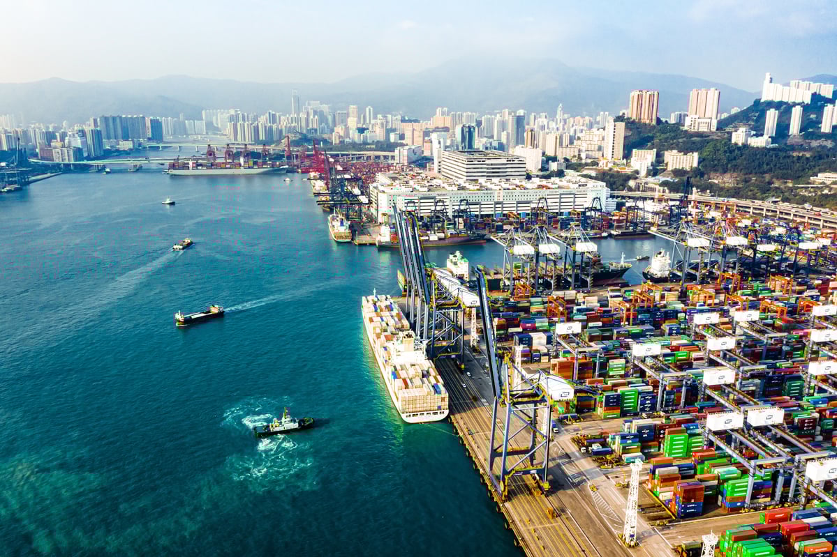 Ships passing through a cargo port in a big city. 