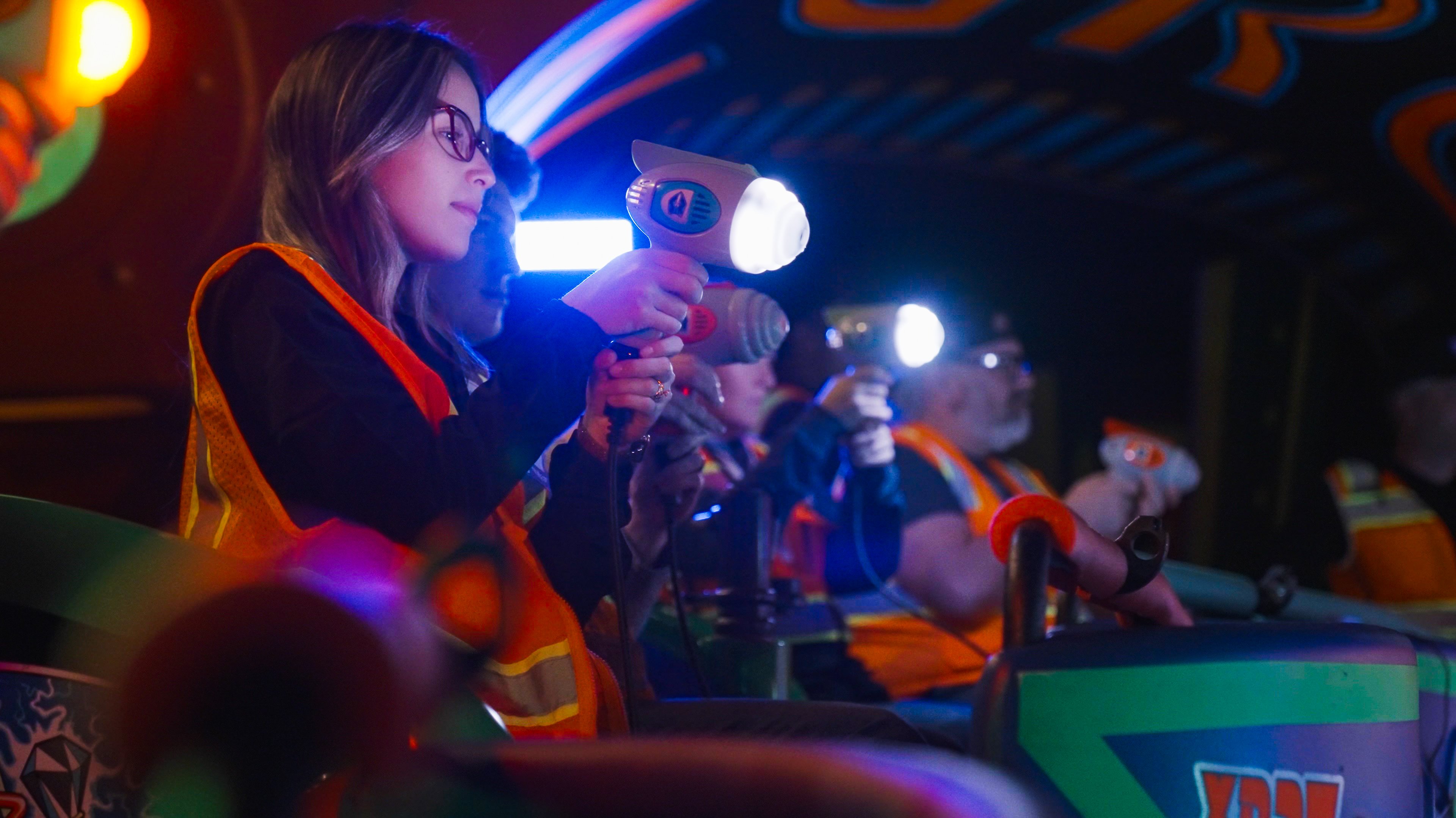 Disney imagineers and cast testing out the new blasters that will play a starring role when the Buzz Lightyear ride upgrade is complete.