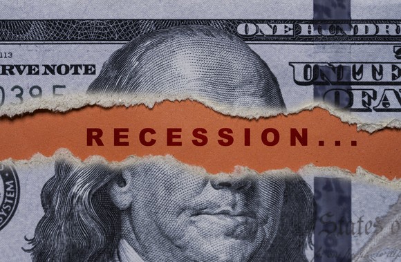 A U.S. $100 billion torn to reveal the word "recession."