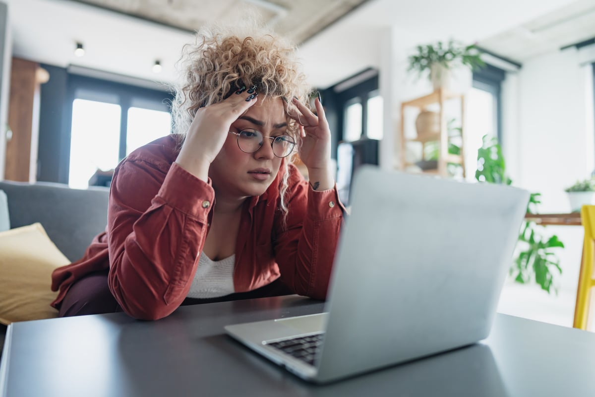 Person looking at a computer worried
