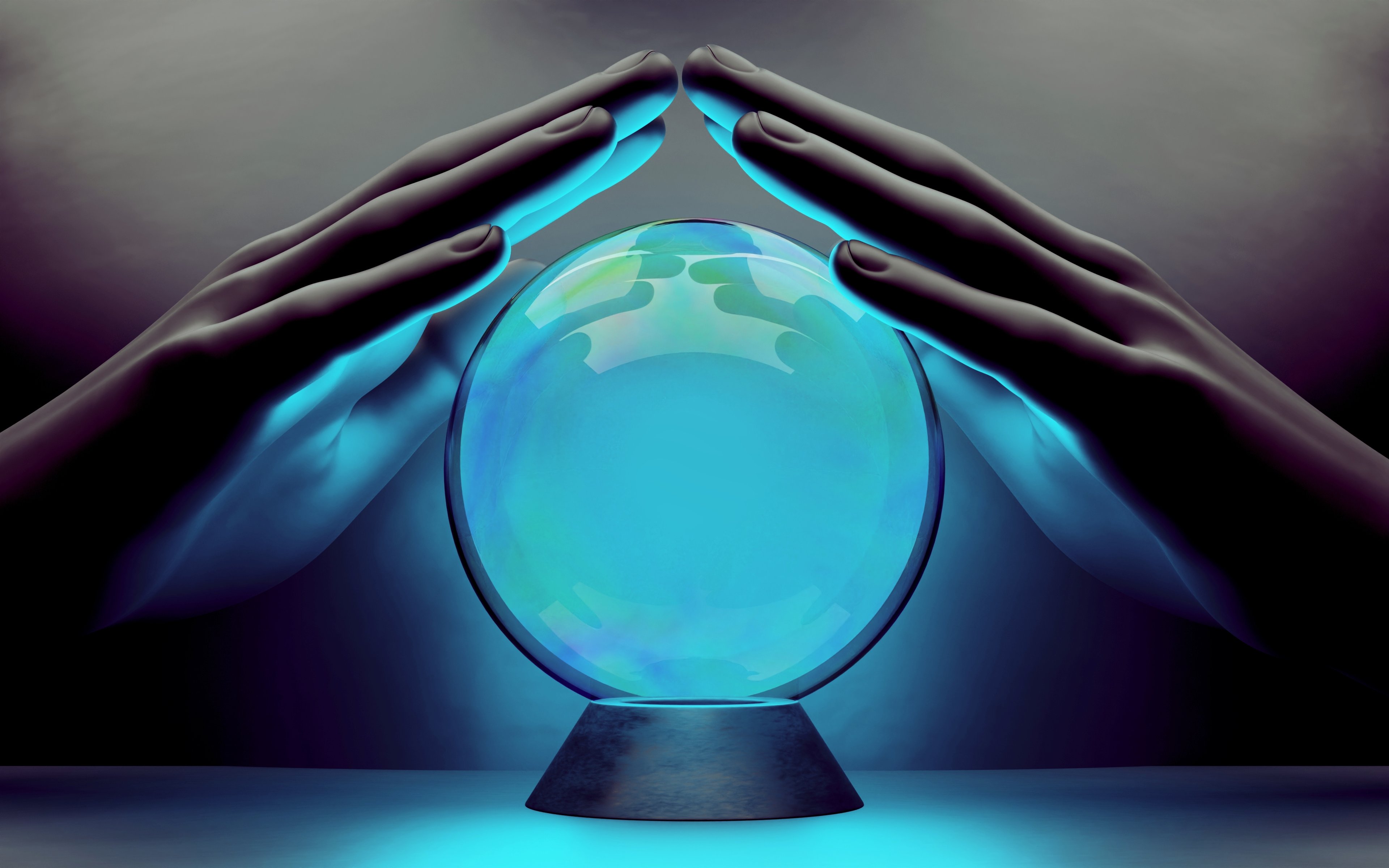 Hands hovering above a crystal ball.