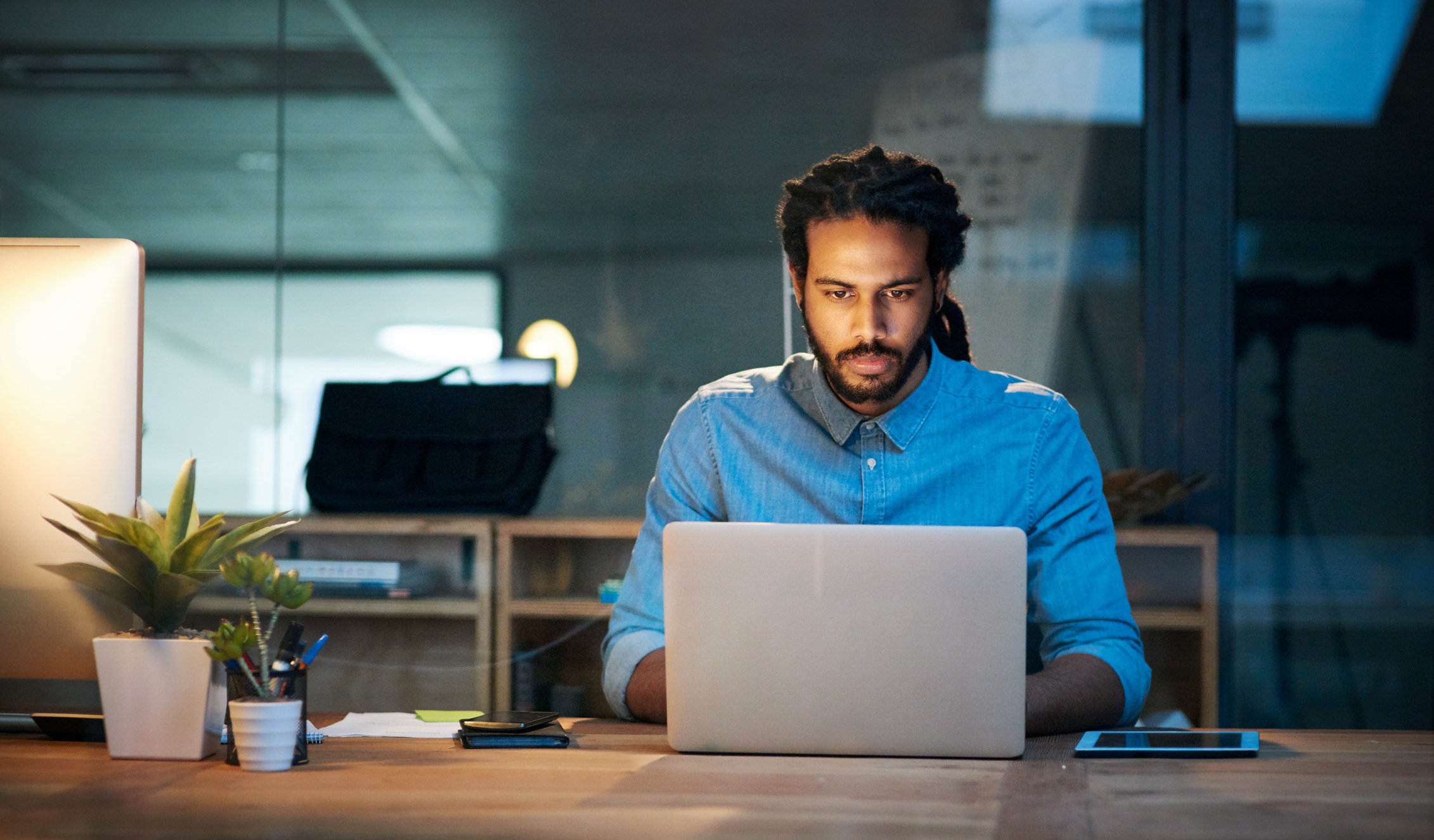 person looking at a laptop at a desk