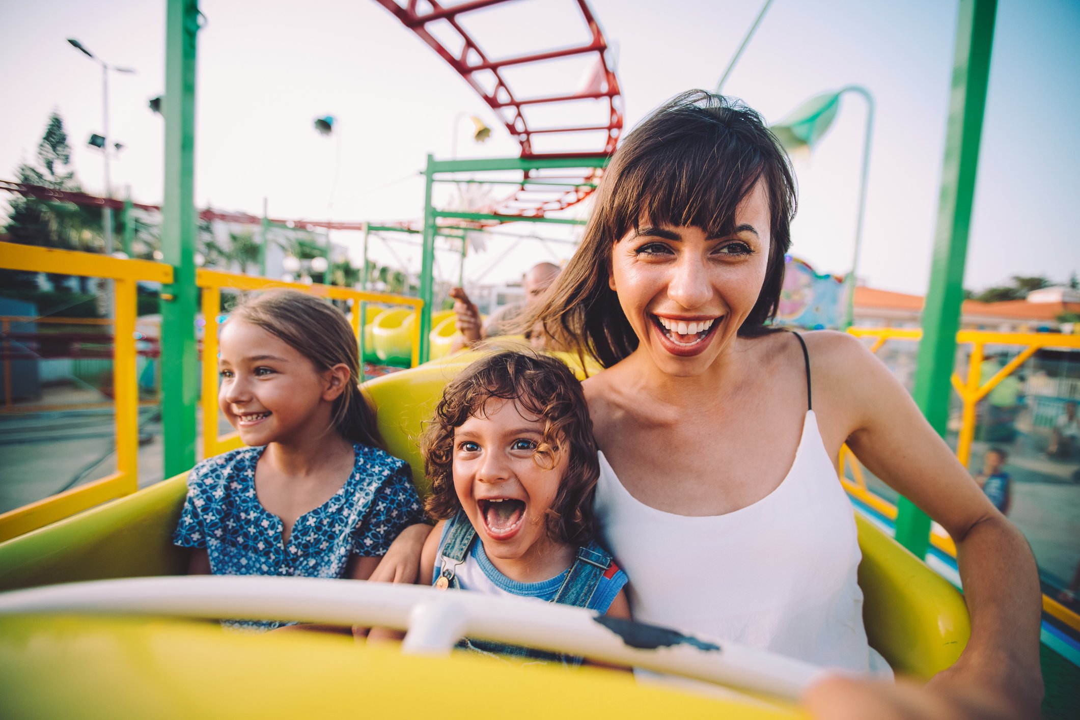 Mom and kids on a rollercoaster.