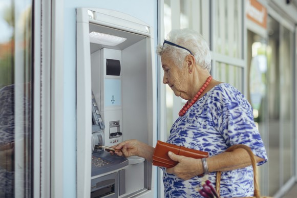 Person using an ATM machine.