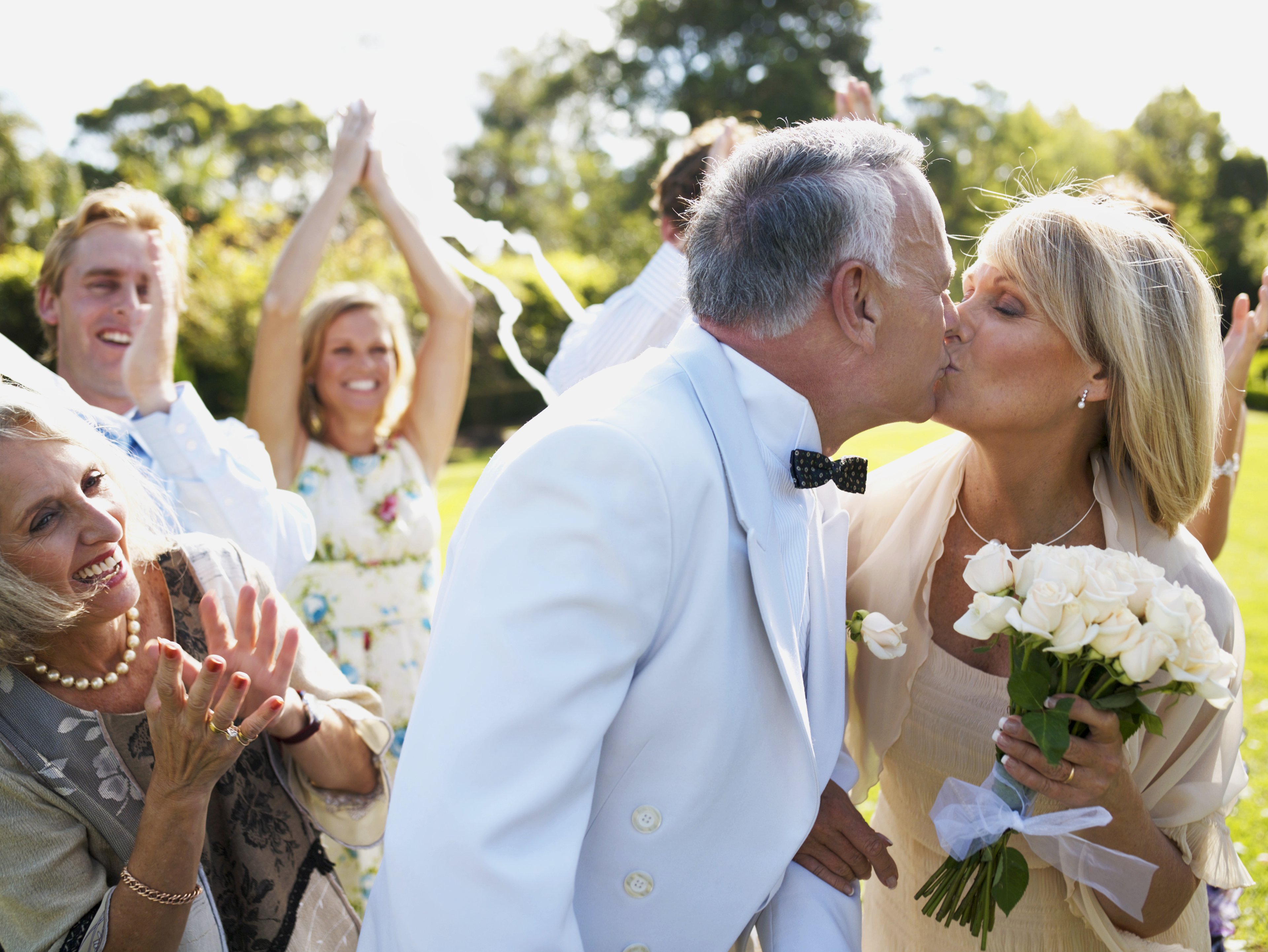 Couple kissing after wedding ceremony.