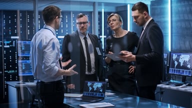 group of investors stand in an office