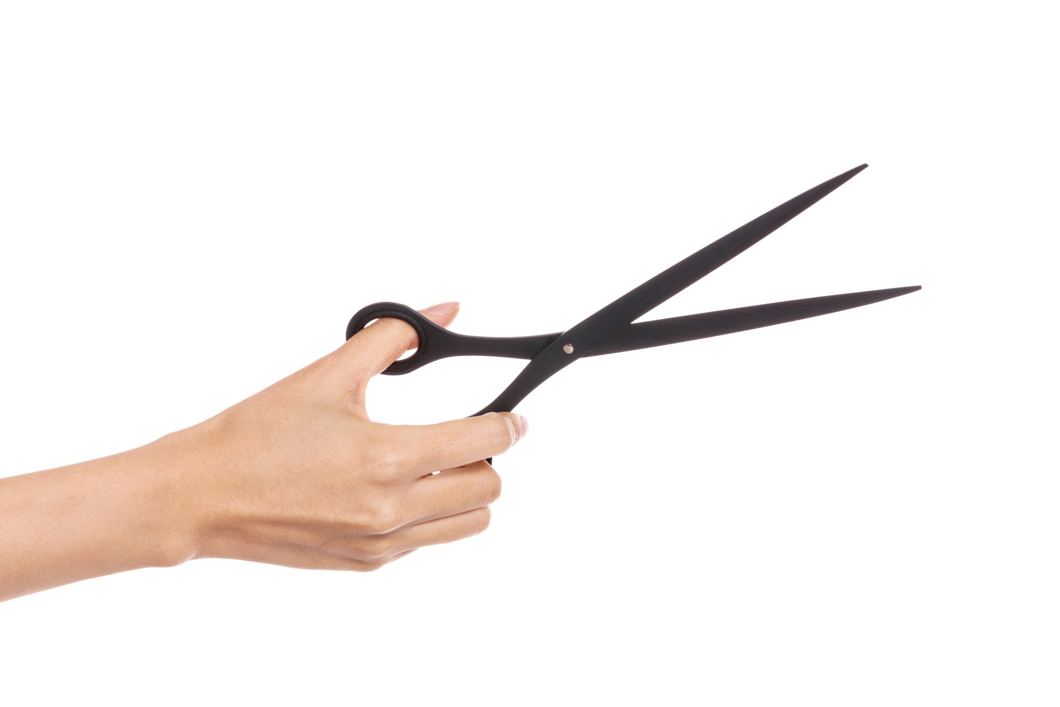 Female hand wielding a large pair of scissors