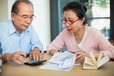 Concerned senior Asian couple
