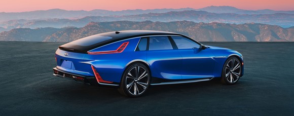A Cadillac Celestiq EV, seen against a backdrop of sunrise over mountains.