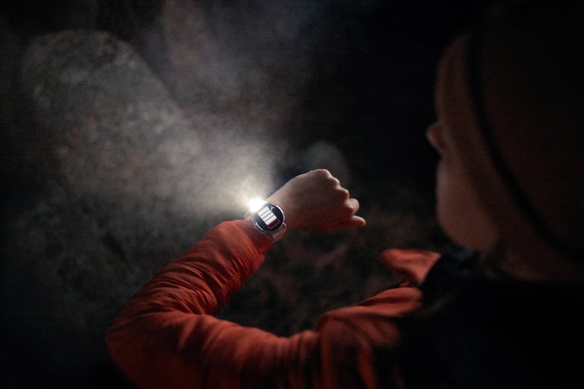 Person looking at their Garmin watch with flashlight capability.