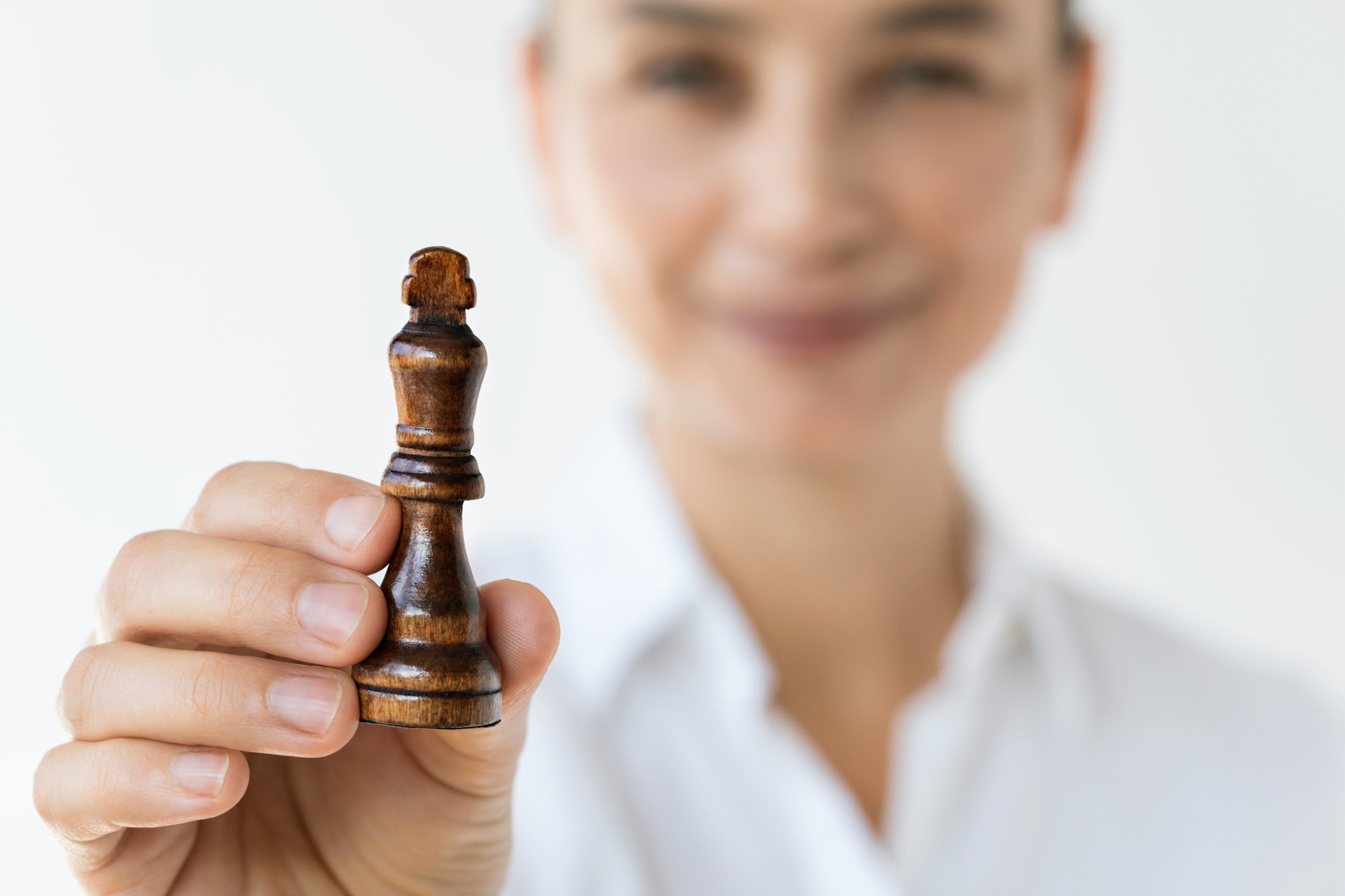 King chess piece held by woman