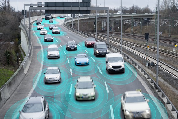 Vehicles on a highway with green sensing circles around them. 