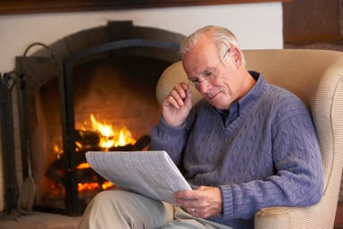 Getty - person in armchair reading newspaper