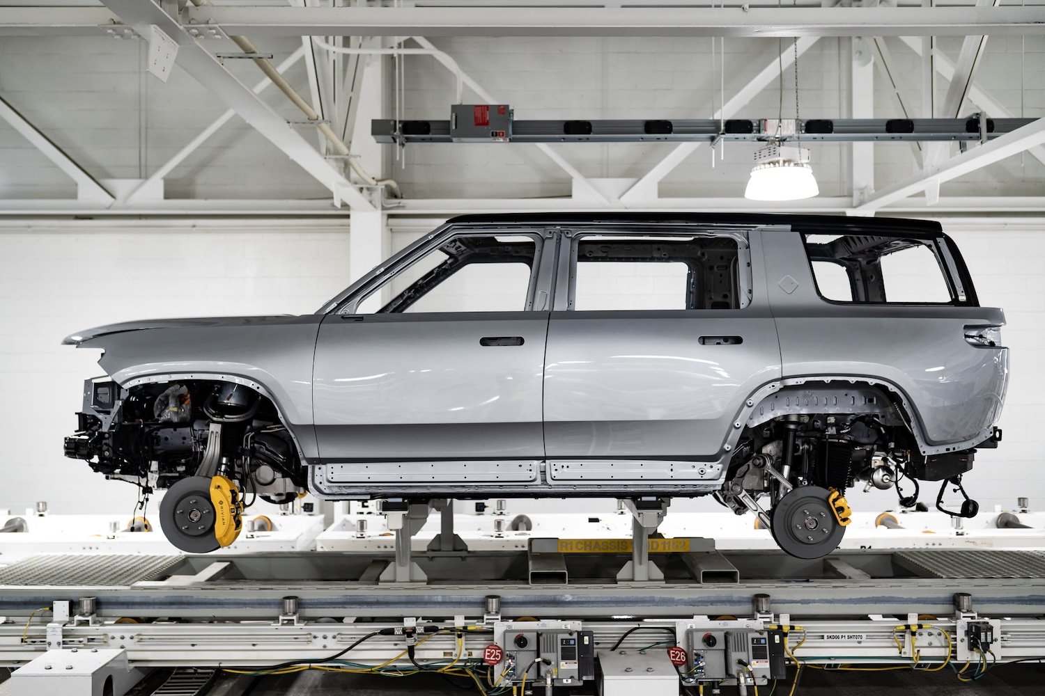 A Rivian SUV body on an assembly line.