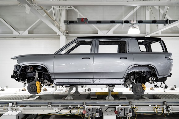A Rivian SUV body on an assembly line.