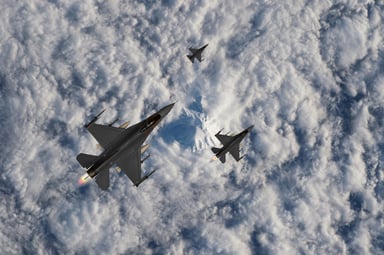 Generic fighter jets flying above clouds.