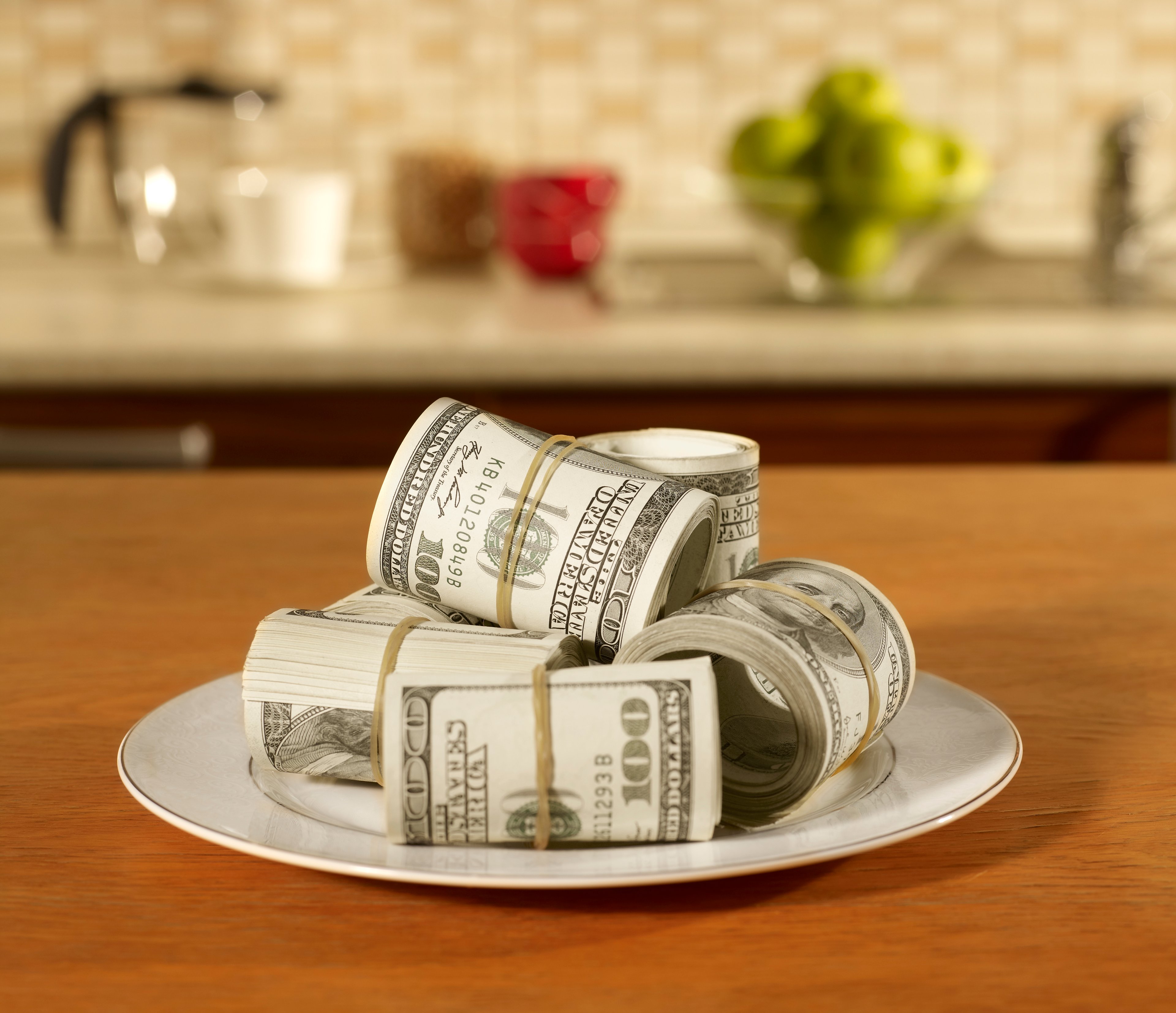 A plate loaded with rolls of US currency