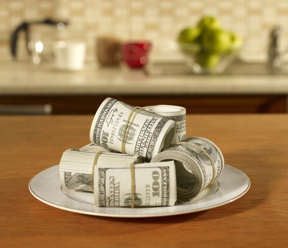 A plate loaded with rolls of U.S. currency.