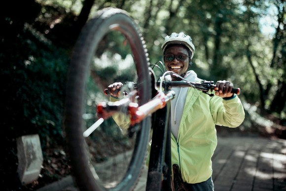 Person holding up a mountain bike.