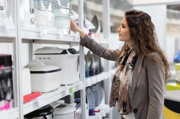 Person shops for appliances in a store. 