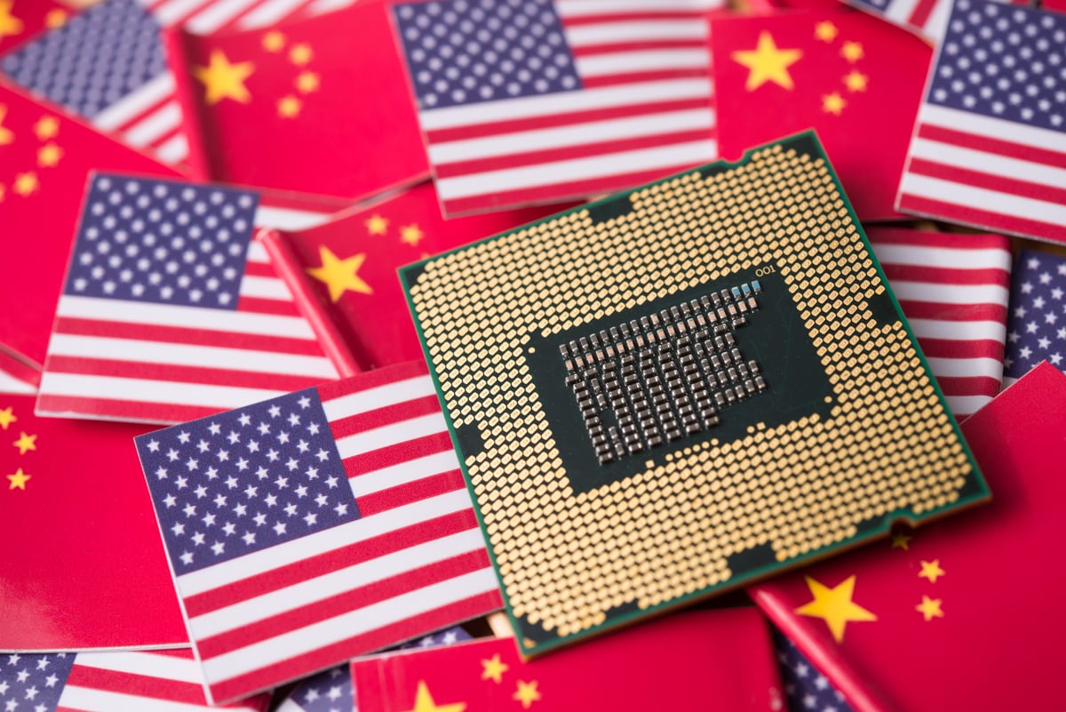 A computer chip on top of American and Chinese flags