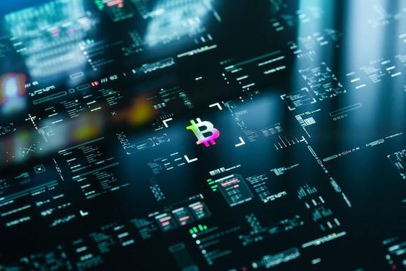 A Bitcoin symbol on a screen.