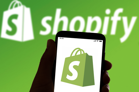 Shopify corporate logo displayed on a smartphone.