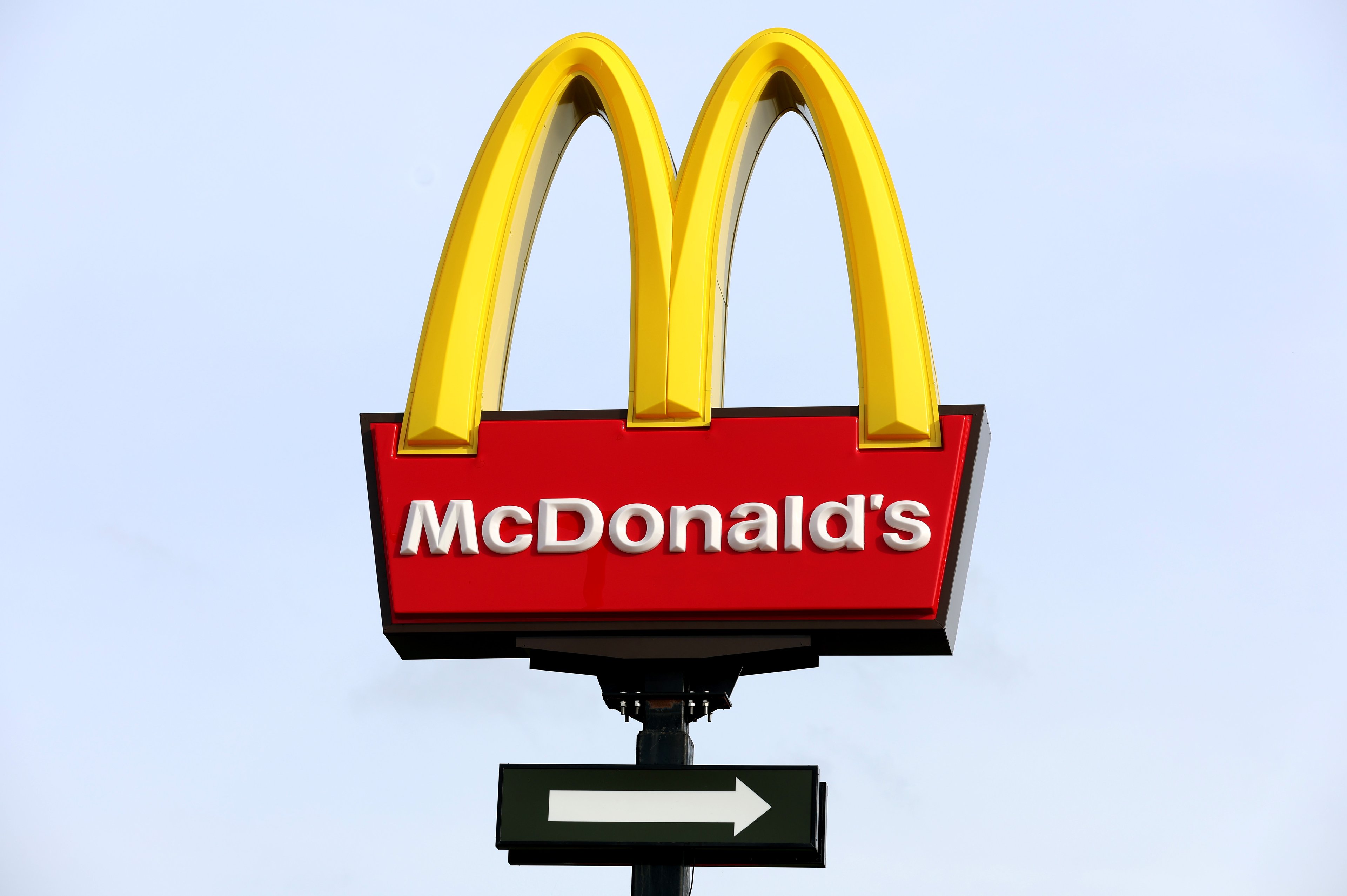 A traditional McDonald's sign with the "golden arches" forming an M with a red square underneath saying McDonald's.